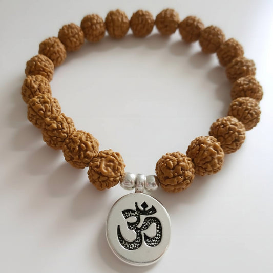 Brown beaded bracelet with a silver pendant featuring an Om symbol on a white background