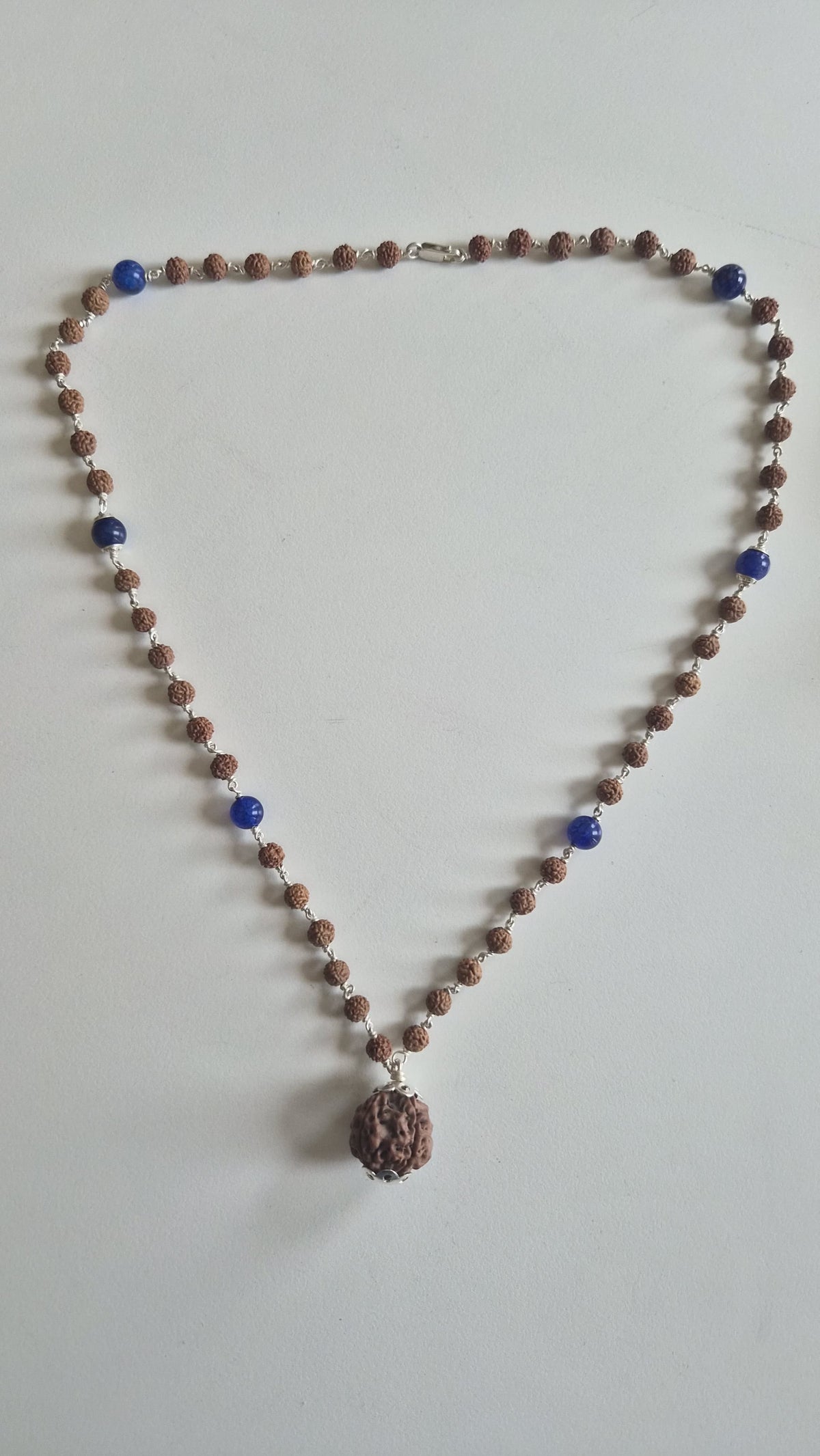 Blue lapis lazuli and rudraksha mala beads on silver links
