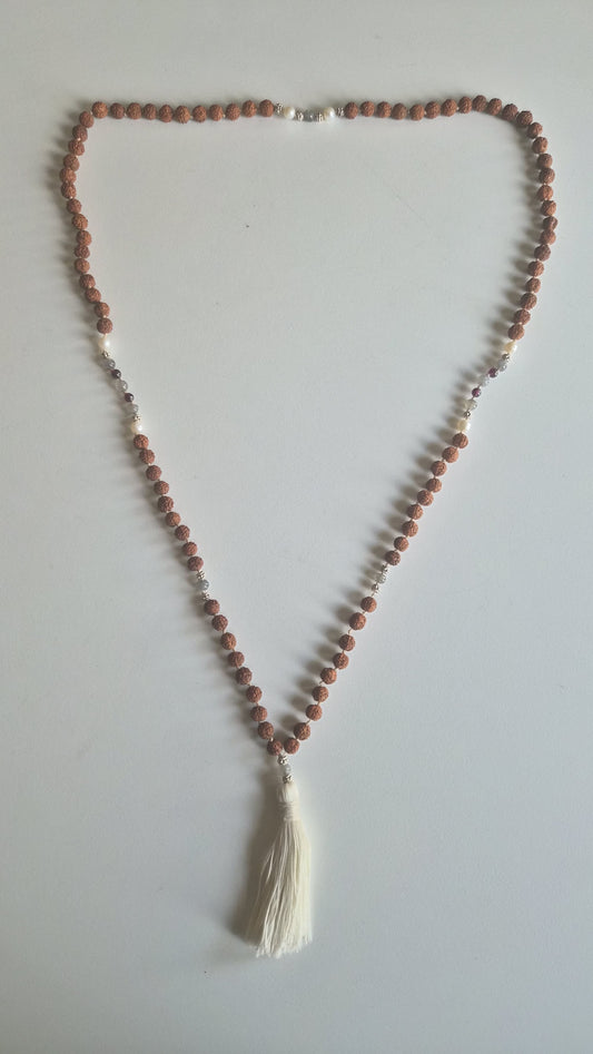 Silver spacer links and silk tassel on rudraksha mala