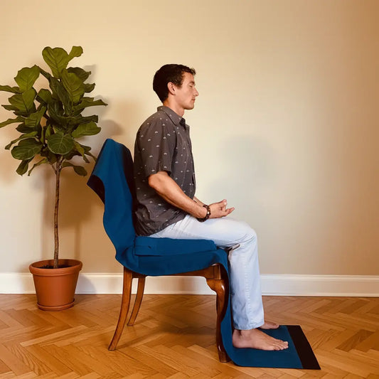 Meditating upright in a chair with a silk and wool blanket
