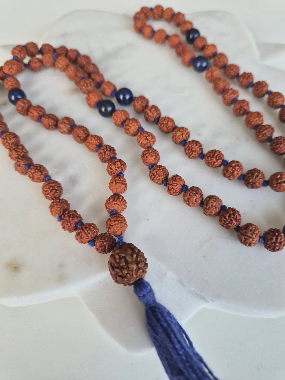 A handcrafted rudraksha and lapis mala, a meaningful gift for a meditator