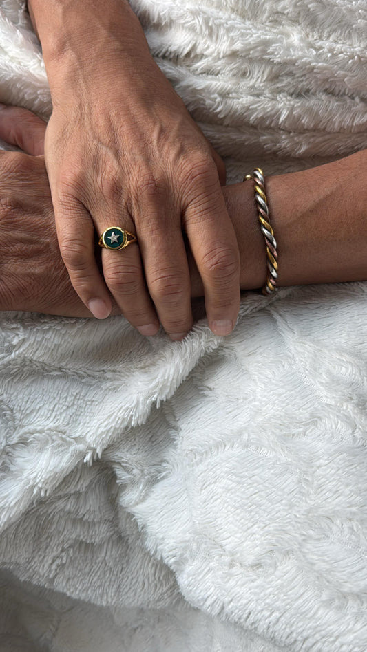 Two hands holding each other on a white textured surface