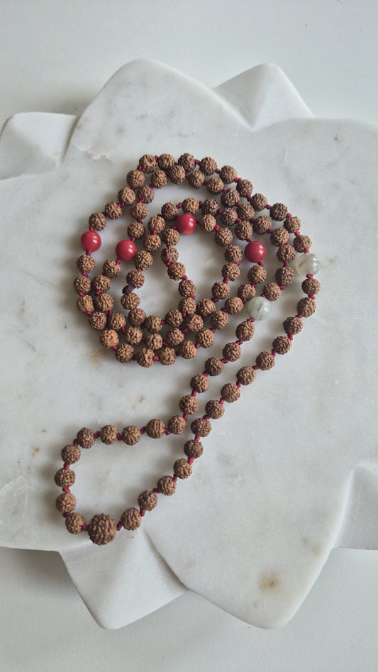 Rudraksha bead mala with red accent beads and silver links