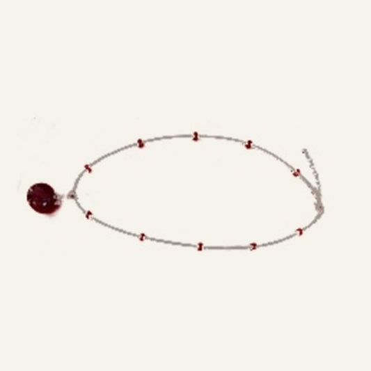 Actual red Venetian glass chakra pendant on handmade beaded chain against ivory background